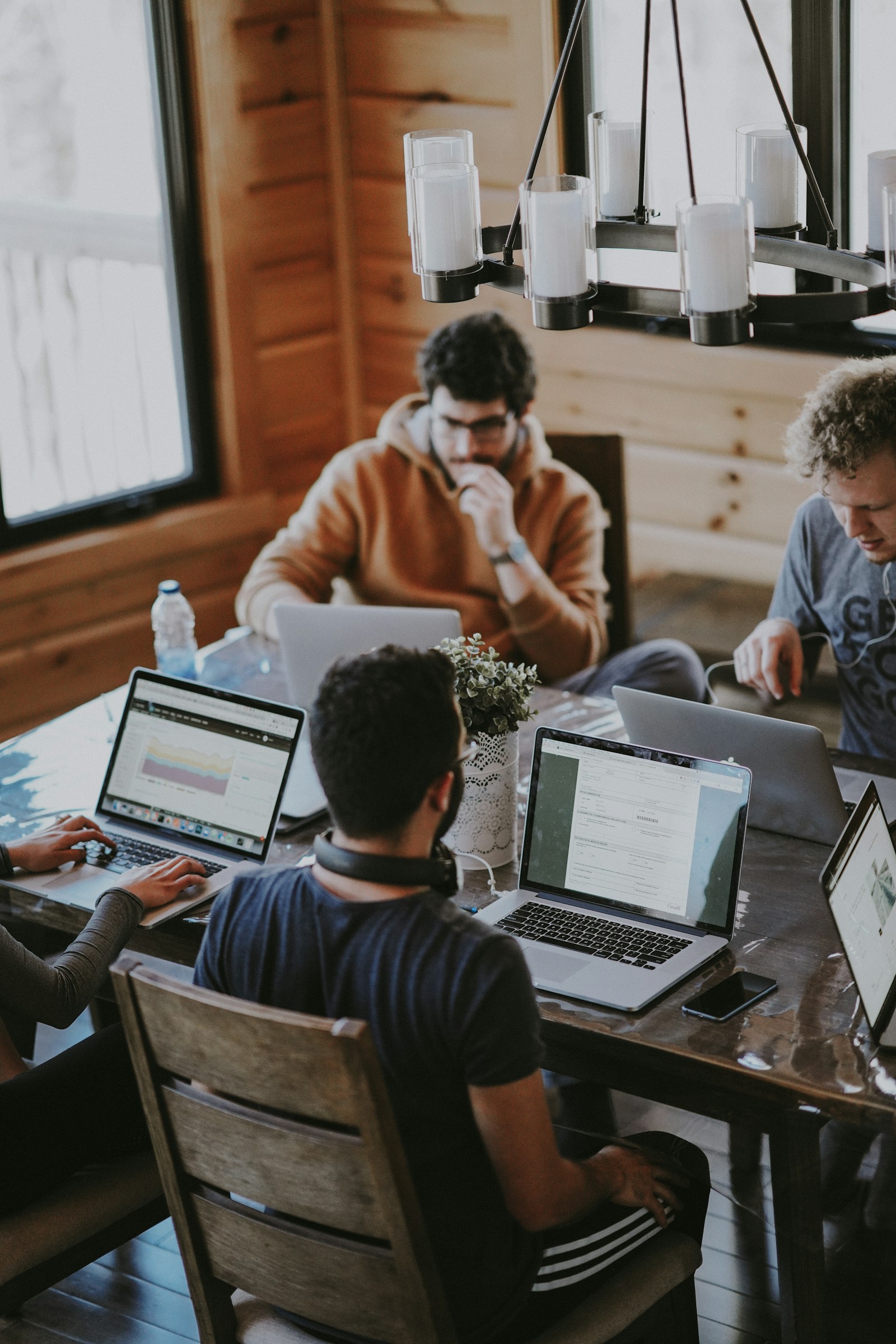People collaborating around a laptop in a bright workspace